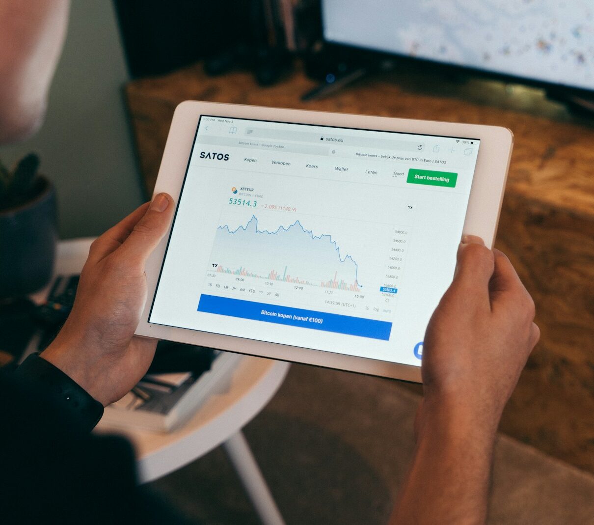 a person holding a tablet with a chart on it